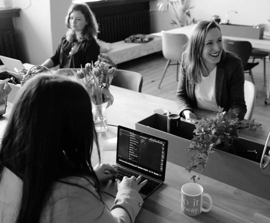 A group of people sitting around a meeting table